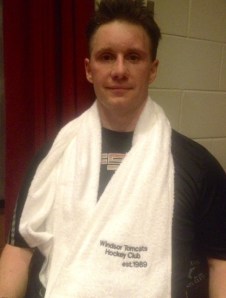 Rocky sits with his new Tomcat towel, a player mainstay.